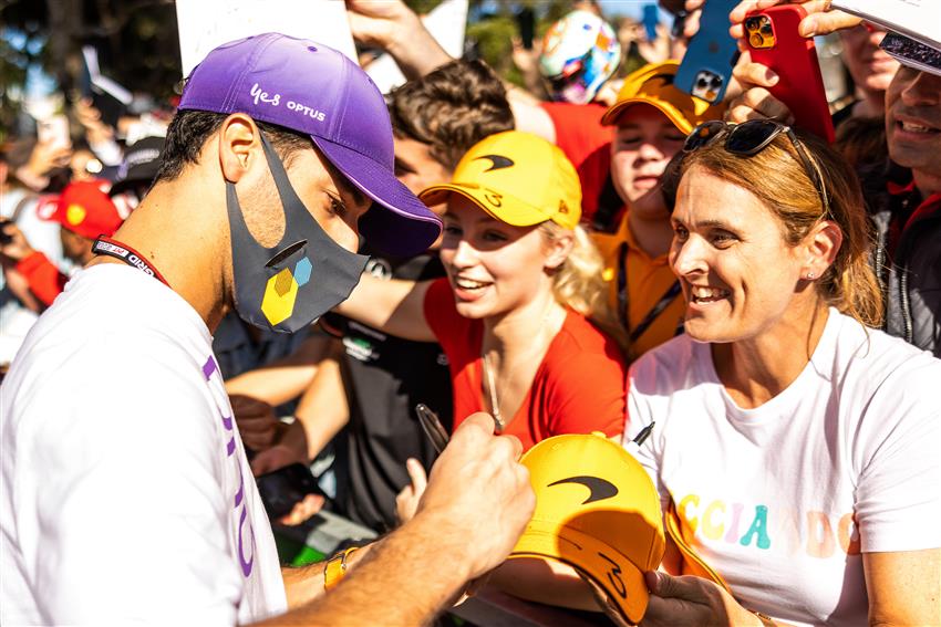 F1 race fans with driver